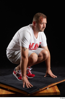  Louis  2 dressed grey shorts kneeling red sneakers sports white t shirt whole body 0008.jpg